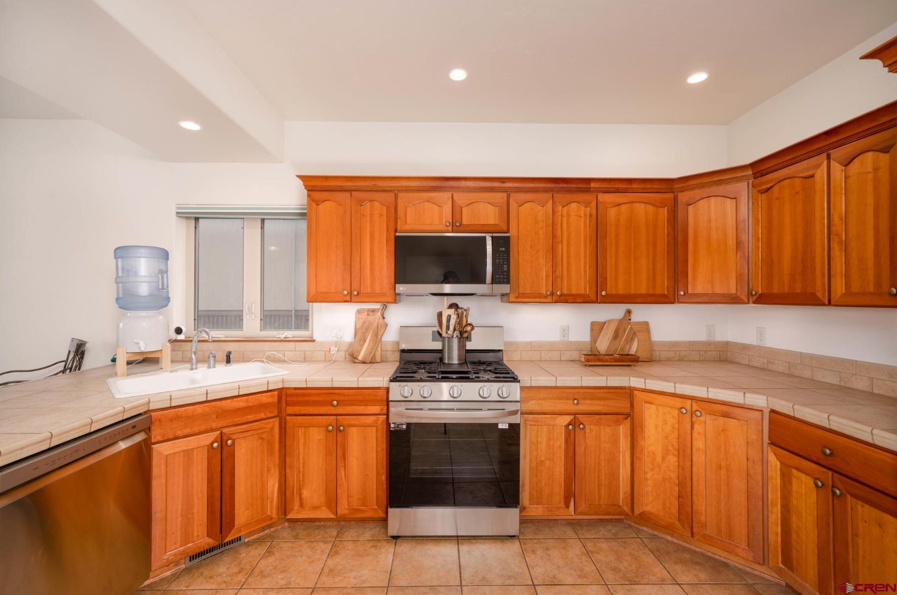 416 Amy Way Ridgway, CO 81432 - Photo 9 of 26 a kitchen with a sink stove top oven and cabinets
