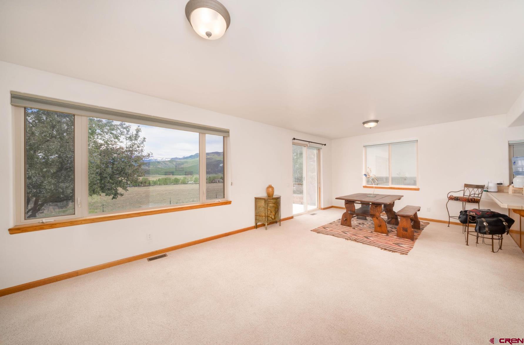 416 Amy Way Ridgway, CO 81432 - Photo 10 of 26 an empty room with furniture and windows