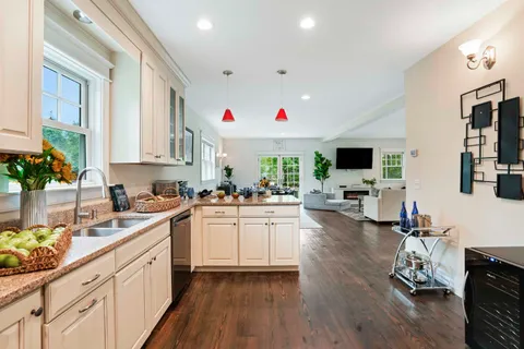a kitchen with sink cabinets and wooden floor
