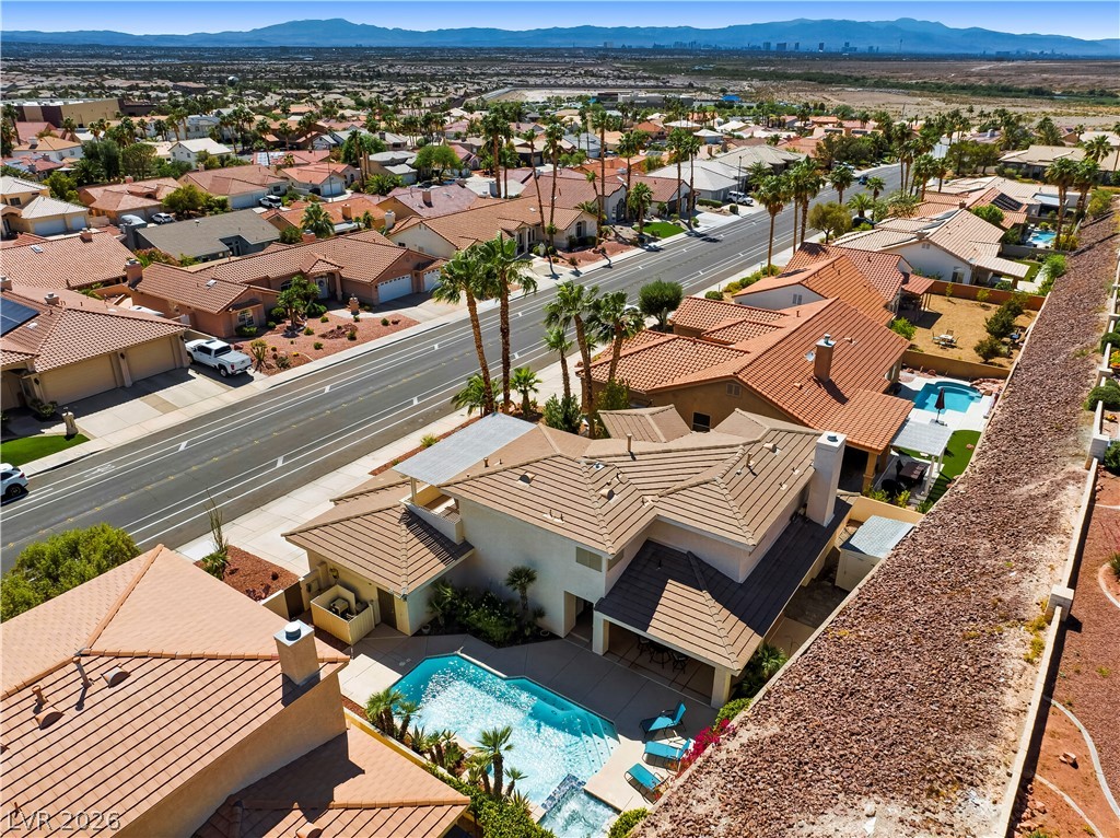 1135 Calico Ridge Drive Henderson, NV 89011 - Photo 63 of 86 An aerial perspective showcases a vibrant neighborhood with desert-friendly landscaping and a sparkling pool.