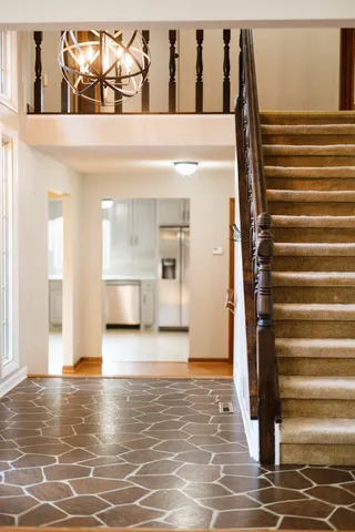 a living room with furniture a chandelier and a fireplace