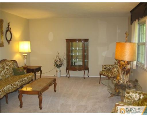 210 Bar Harbor Road Freehold, NJ 07728 - Photo 2 of 9 a living room with furniture and a lamp
