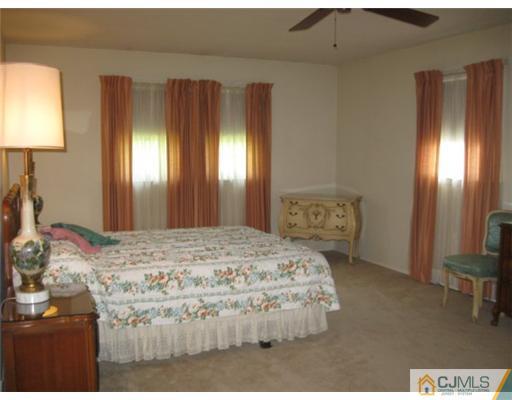 210 Bar Harbor Road Freehold, NJ 07728 - Photo 7 of 9 a bedroom with a bed and a dresser in it