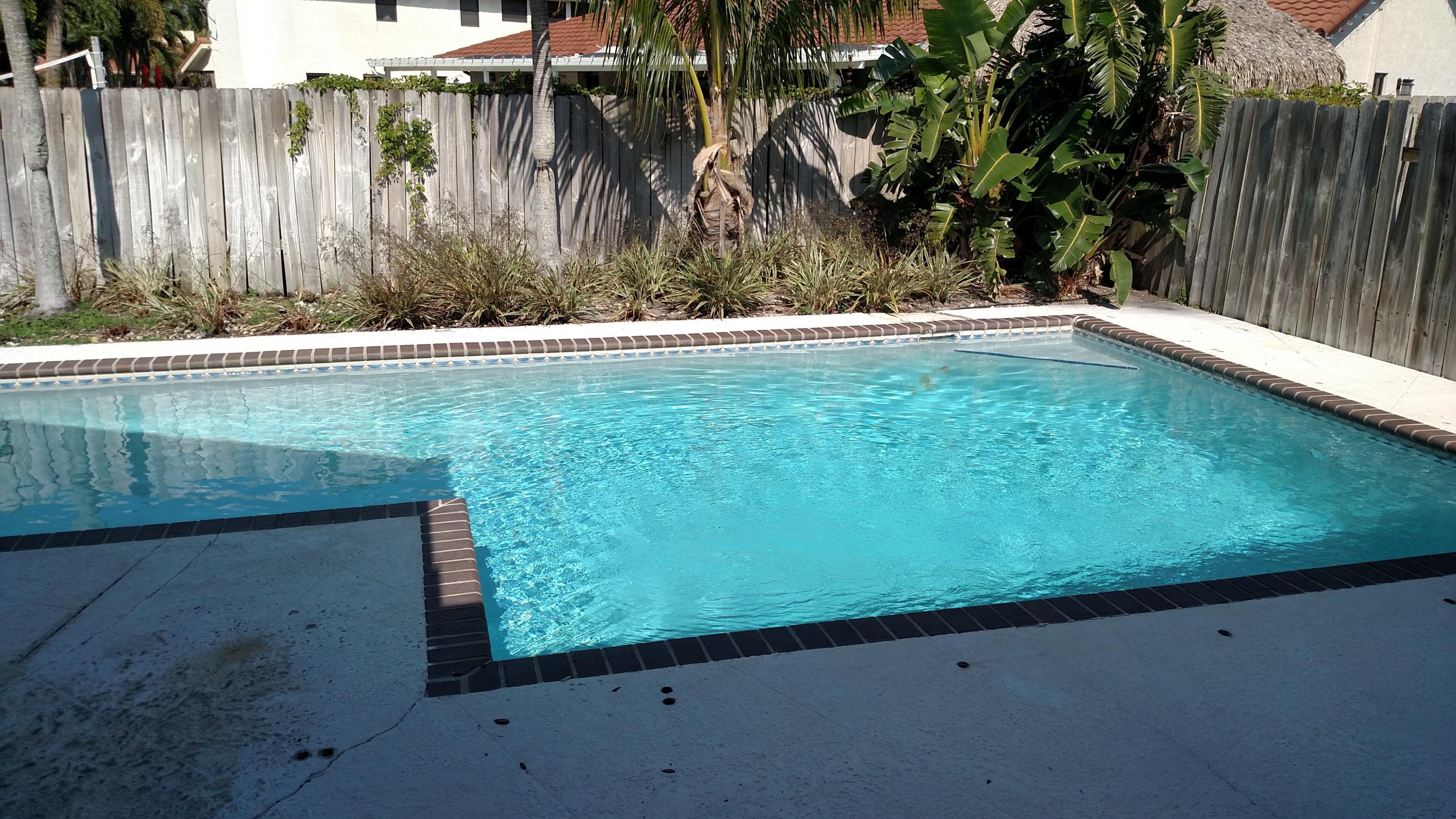 451 West Conference Drive Boca Raton, FL 33486 - Photo 2 of 6 a backyard of a house with lots of green space