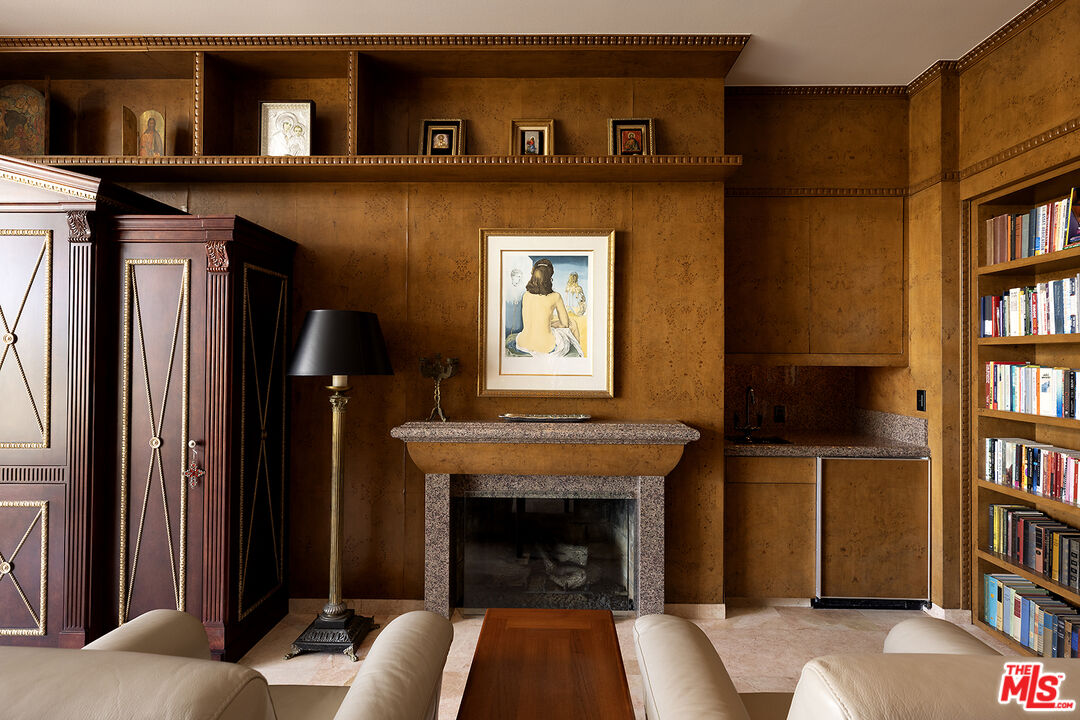 70418 Placerville Road Rancho Mirage, CA 92270 - Photo 14 of 28 a living room with a fireplace and a book shelf