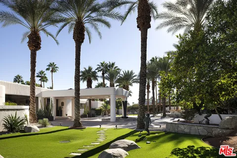 a swimming pool with outdoor seating and yard