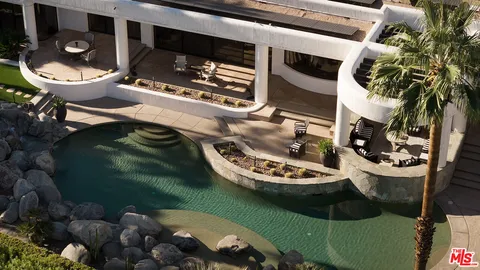 a table with chairs and a potted plant