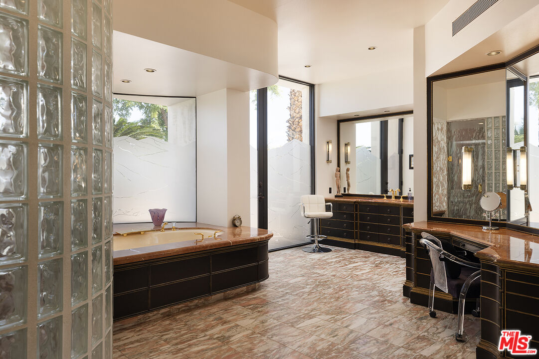 70418 Placerville Road Rancho Mirage, CA 92270 - Photo 22 of 42 a room with a bed and a view of bathroom