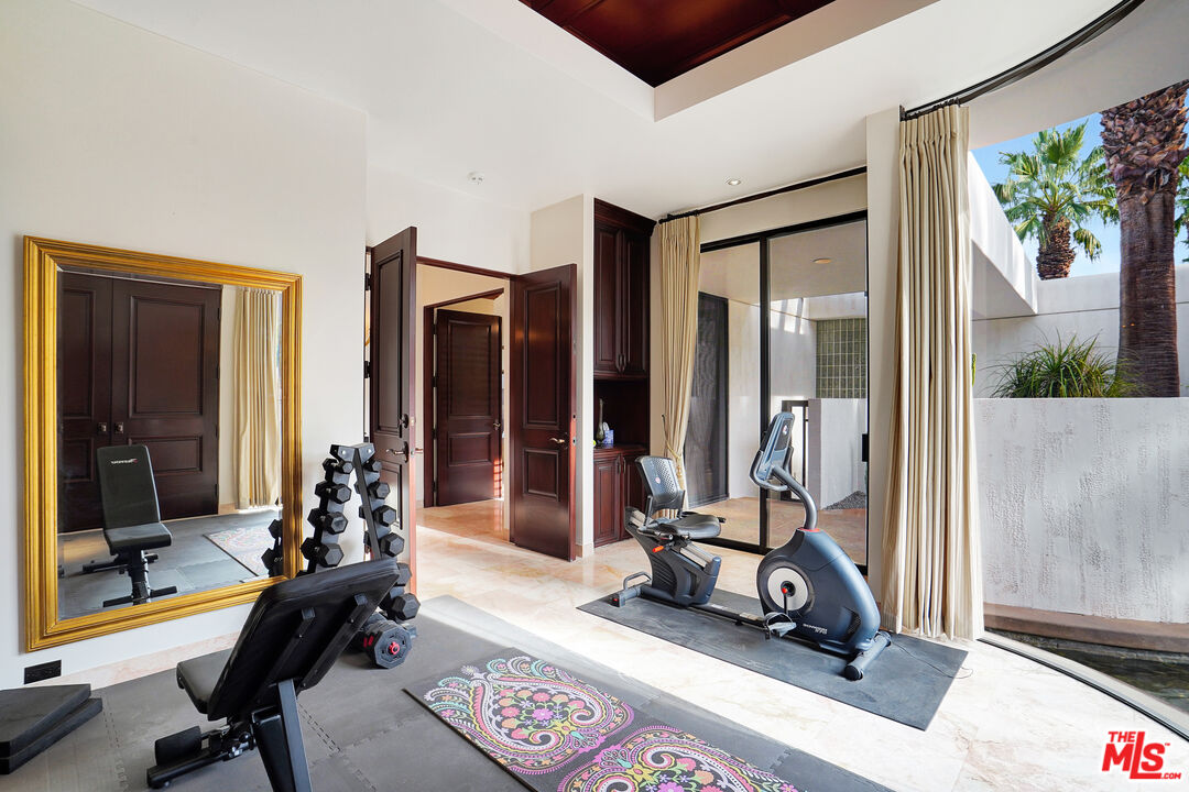 70418 Placerville Road Rancho Mirage, CA 92270 - Photo 27 of 42 a view of a room with gym equipment and floor to ceiling window
