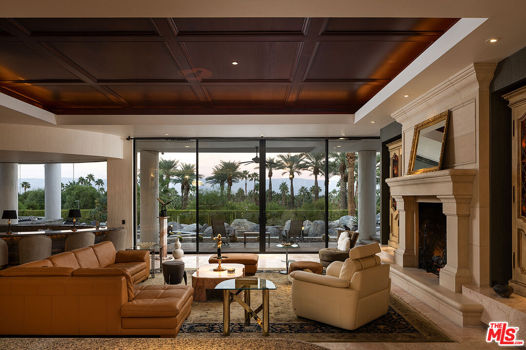 70418 Placerville Road Rancho Mirage, CA 92270 - Photo 4 of 28 a living room with furniture large windows and a fireplace