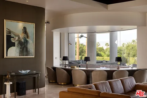 a living room with furniture and large windows