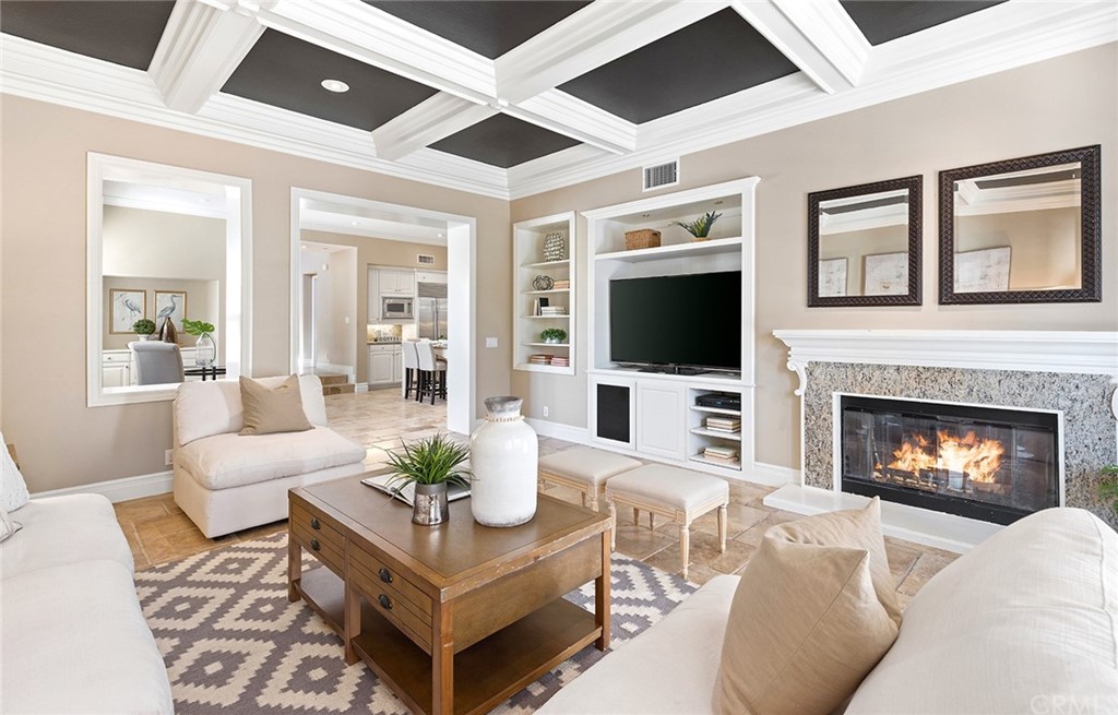 10464 Caribou Way Tustin, CA 92782 - Photo 11 of 34 a living room with furniture a fireplace and a flat screen tv