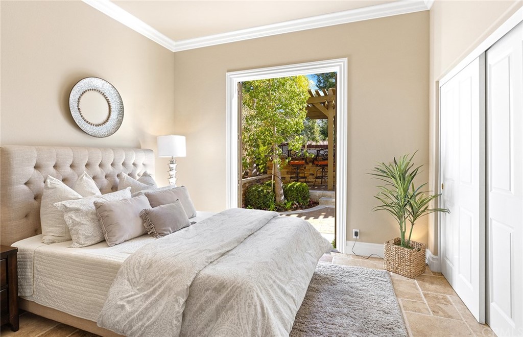 10464 Caribou Way Tustin, CA 92782 - Photo 12 of 34 a bedroom with a large bed and a large window