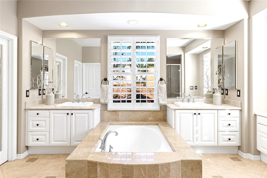 10464 Caribou Way Tustin, CA 92782 - Photo 15 of 34 a large spacious bathroom with a large tub sink vanity and granite