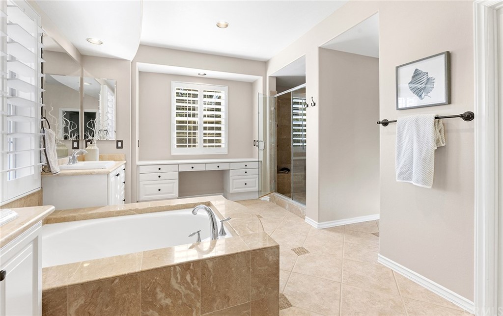 10464 Caribou Way Tustin, CA 92782 - Photo 16 of 34 a spacious bathroom with a tub sink and mirror