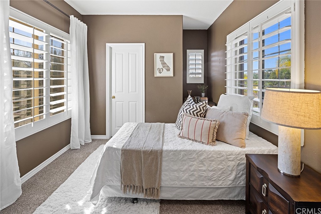 10464 Caribou Way Tustin, CA 92782 - Photo 17 of 34 a bedroom with a bed and wooden floor