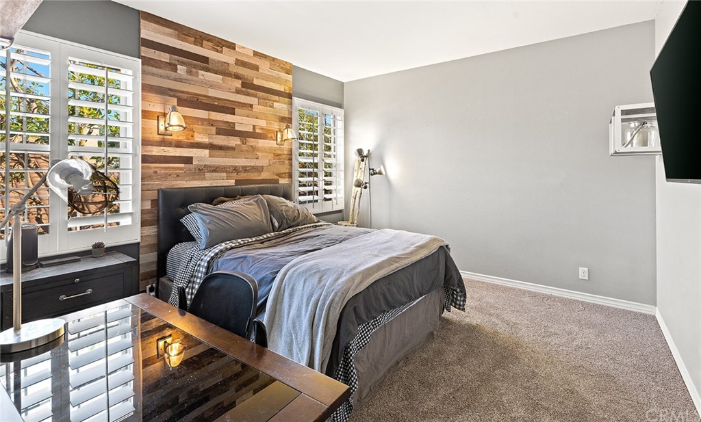 10464 Caribou Way Tustin, CA 92782 - Photo 19 of 34 a bedroom with a bed and a flat tv screen on dresser