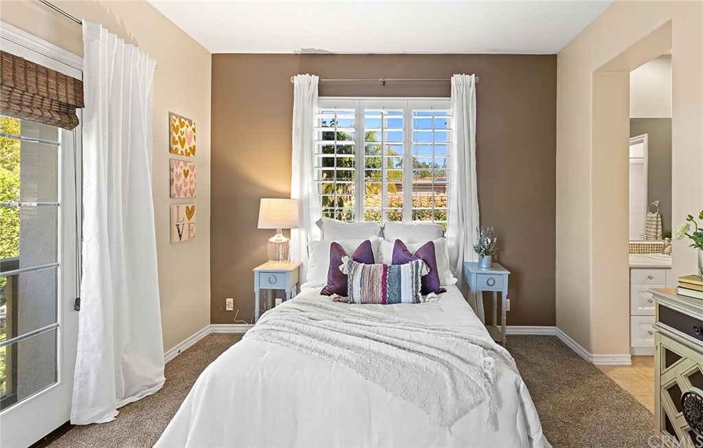 10464 Caribou Way Tustin, CA 92782 - Photo 20 of 34 a bedroom with a bed and a large window