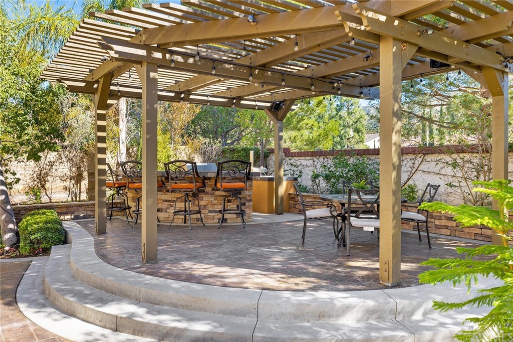 10464 Caribou Way Tustin, CA 92782 - Photo 26 of 34 a view of a patio with a table and chairs and potted plants