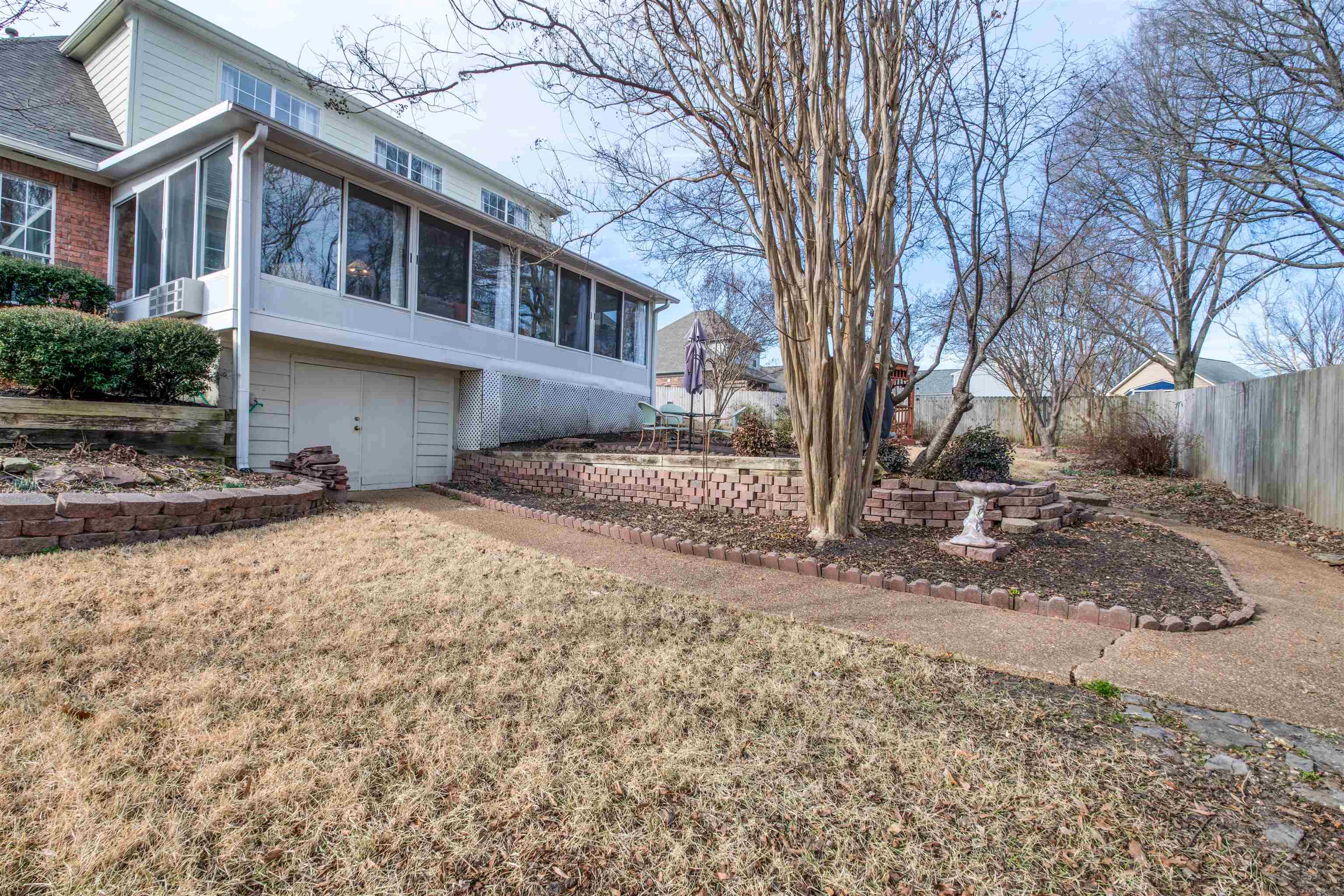 3234 Brunswick Road Bartlett, TN 38133 - Photo 29 of 31 View of property exterior with a sunroom and a lawn