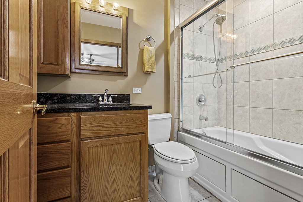 12401 68th Court Palos Heights, IL 60463 - Photo 11 of 24 a bathroom with a sink a toilet and shower