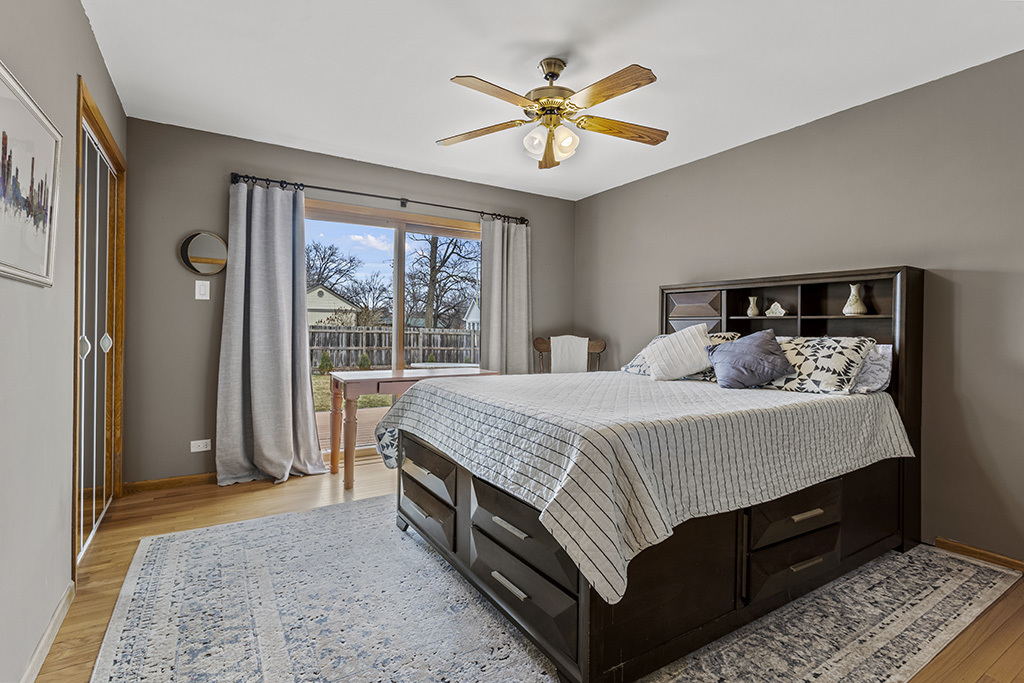 12401 68th Court Palos Heights, IL 60463 - Photo 12 of 24 a bed sitting in a bedroom next to a window