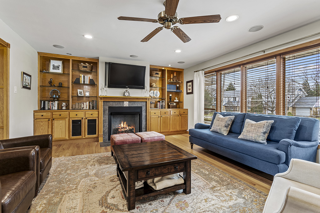 12401 68th Court Palos Heights, IL 60463 - Photo 2 of 24 a living room with furniture a flat screen tv and a fireplace