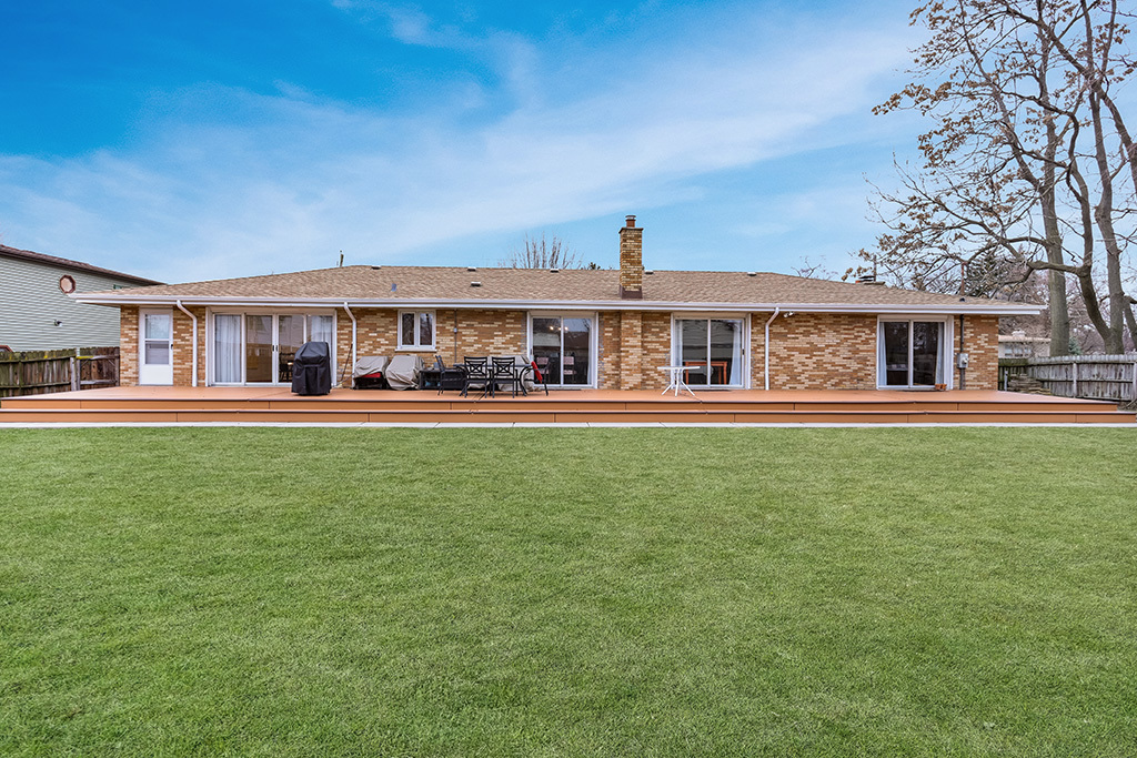 12401 68th Court Palos Heights, IL 60463 - Photo 24 of 24 a front view of a house with a garden and trees