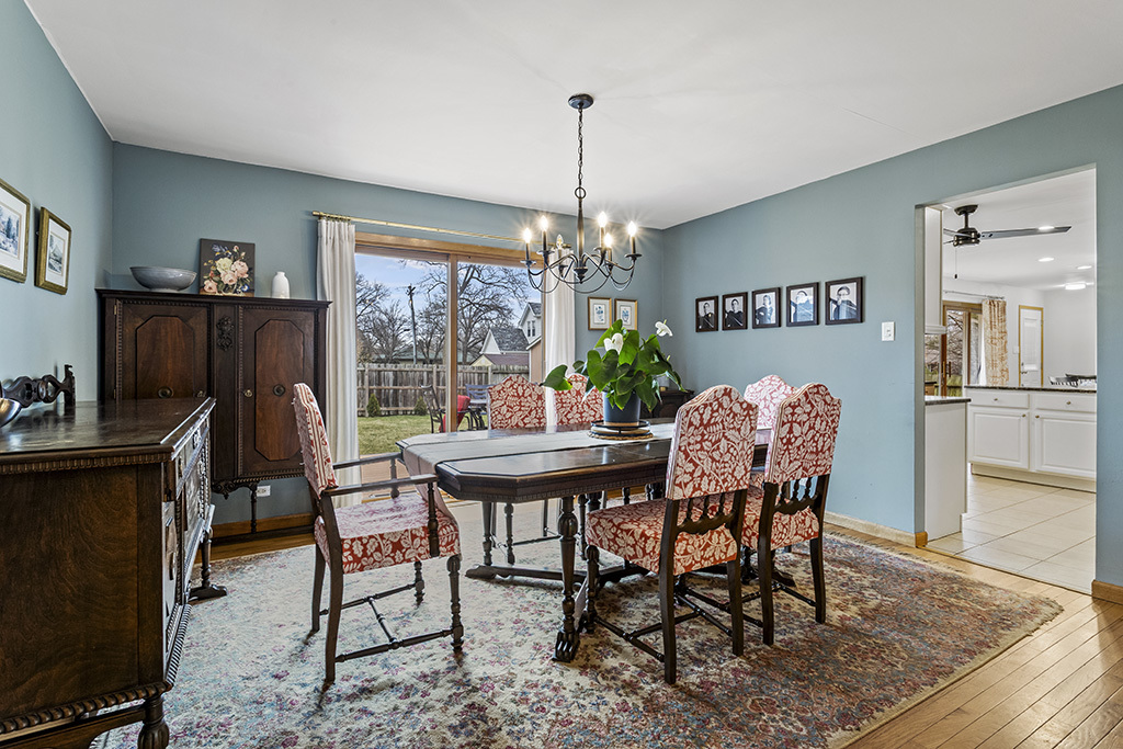 12401 68th Court Palos Heights, IL 60463 - Photo 5 of 24 a dining room with furniture a chandelier and wooden floor