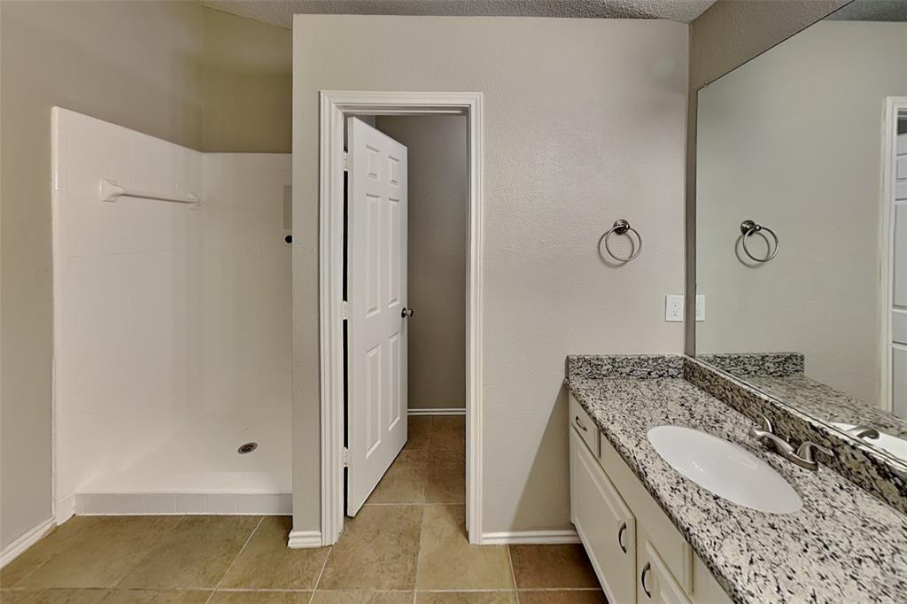 604 Ashby Place Allen, TX 75002 - Photo 11 of 21 a bathroom with a granite countertop sink and a mirror