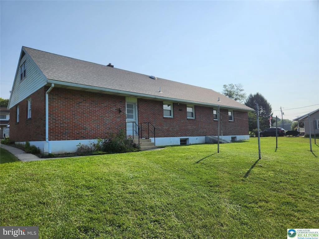 443 Dryville Road Fleetwood, PA 19522 - Photo 11 of 12 a brick house with a big yard and a large trees