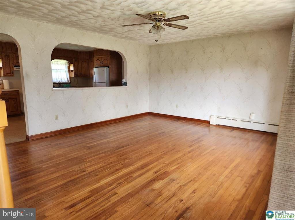443 Dryville Road Fleetwood, PA 19522 - Photo 3 of 12 wooden floor in an empty room with a mirror