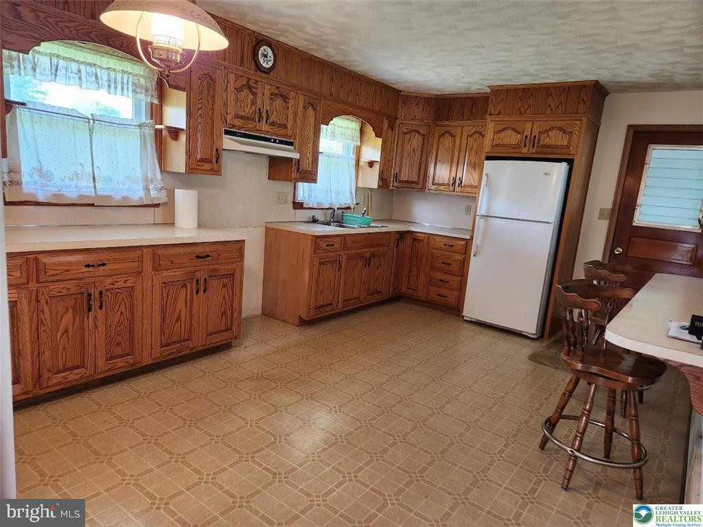 443 Dryville Road Fleetwood, PA 19522 - Photo 5 of 12 a kitchen with granite countertop a sink cabinets and stainless steel appliances