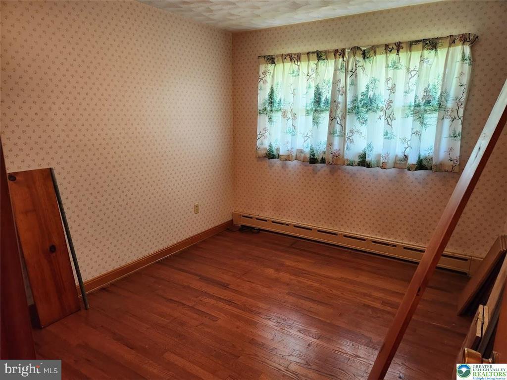 443 Dryville Road Fleetwood, PA 19522 - Photo 9 of 12 a view of empty room with wooden floor and fan