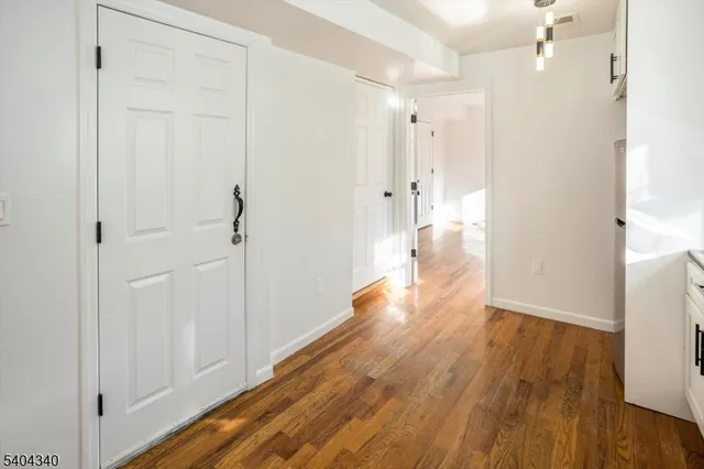 a view of hallway with wooden floor