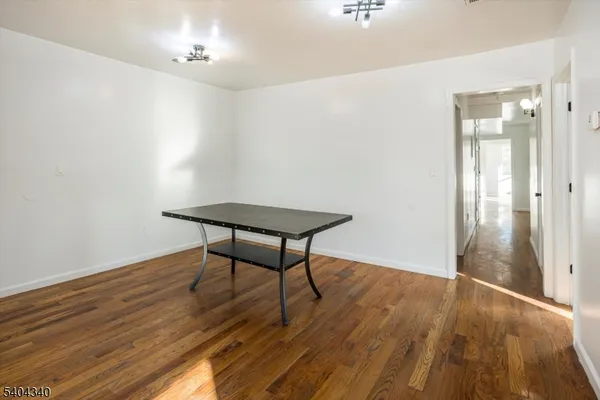 a view of a room with wooden floor and bench