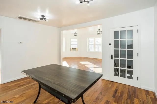 a view of a room with wooden floor and windows