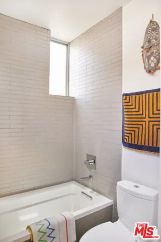 a bathroom with a toilet and a bathtub