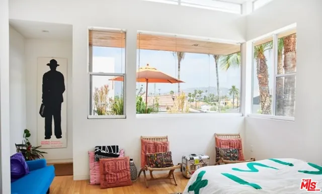 a bedroom with furniture and a window