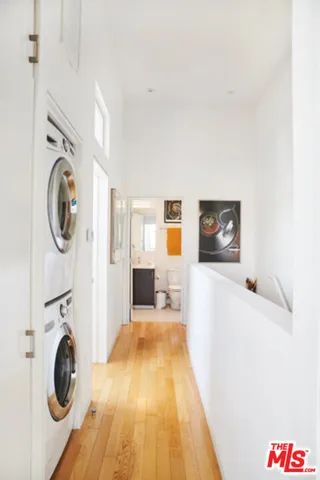 a view of a bedroom with washer and dryer