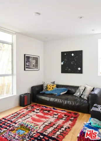 a bedroom with a bed and a lamp on dresser