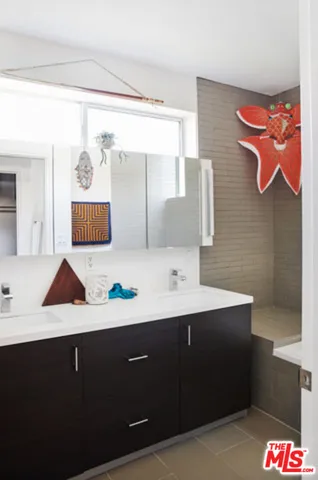 a bathroom with a sink vanity and mirror
