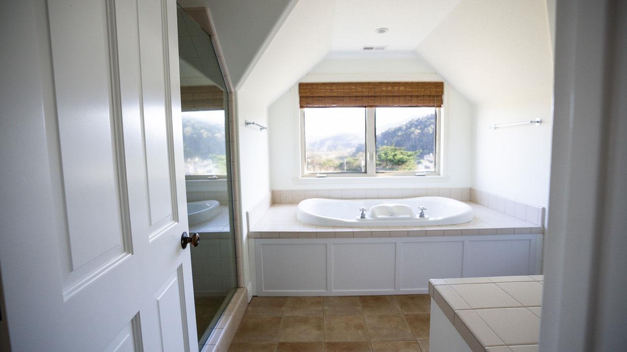 189 Kent Road Pacifica, CA 94044 - Photo 11 of 15 a bathroom with a granite countertop sink and a bathtub