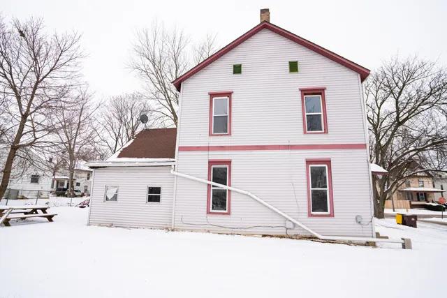 a view of a white house with a large space