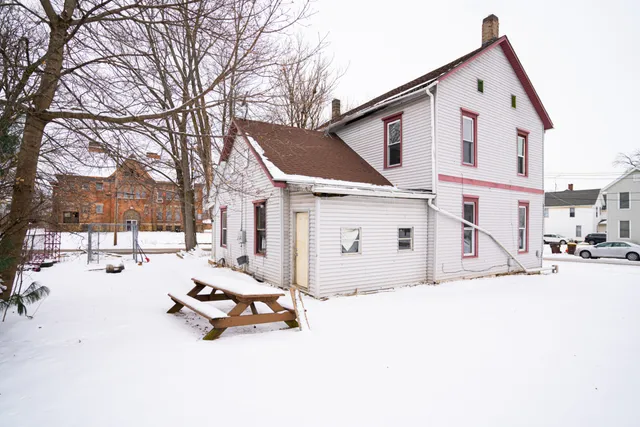 a view of a white house covered in snow