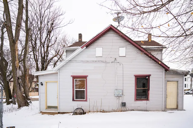 a view of a house with snow on the road