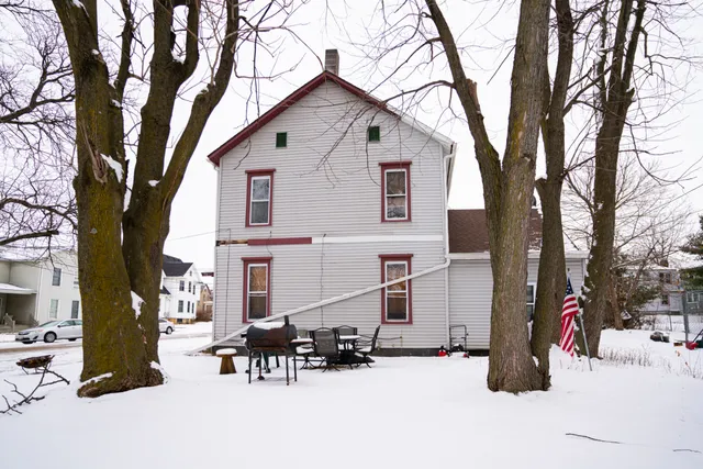 a view of a house with a tree in the background