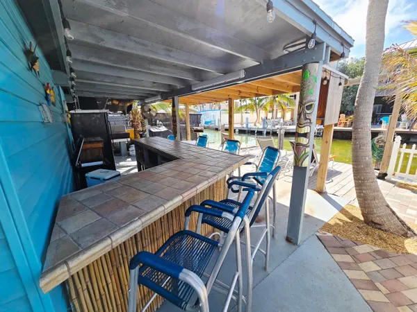 a view of a patio with table and chairs