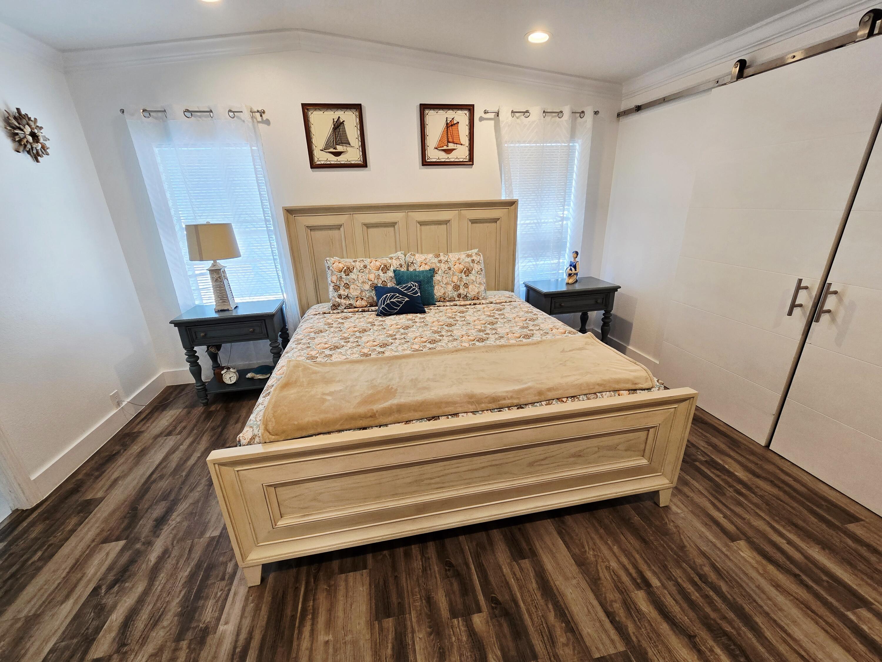 837 91st St Ocean Marathon, FL 33050 - Photo 15 of 27 a bedroom with a bed and wooden floor
