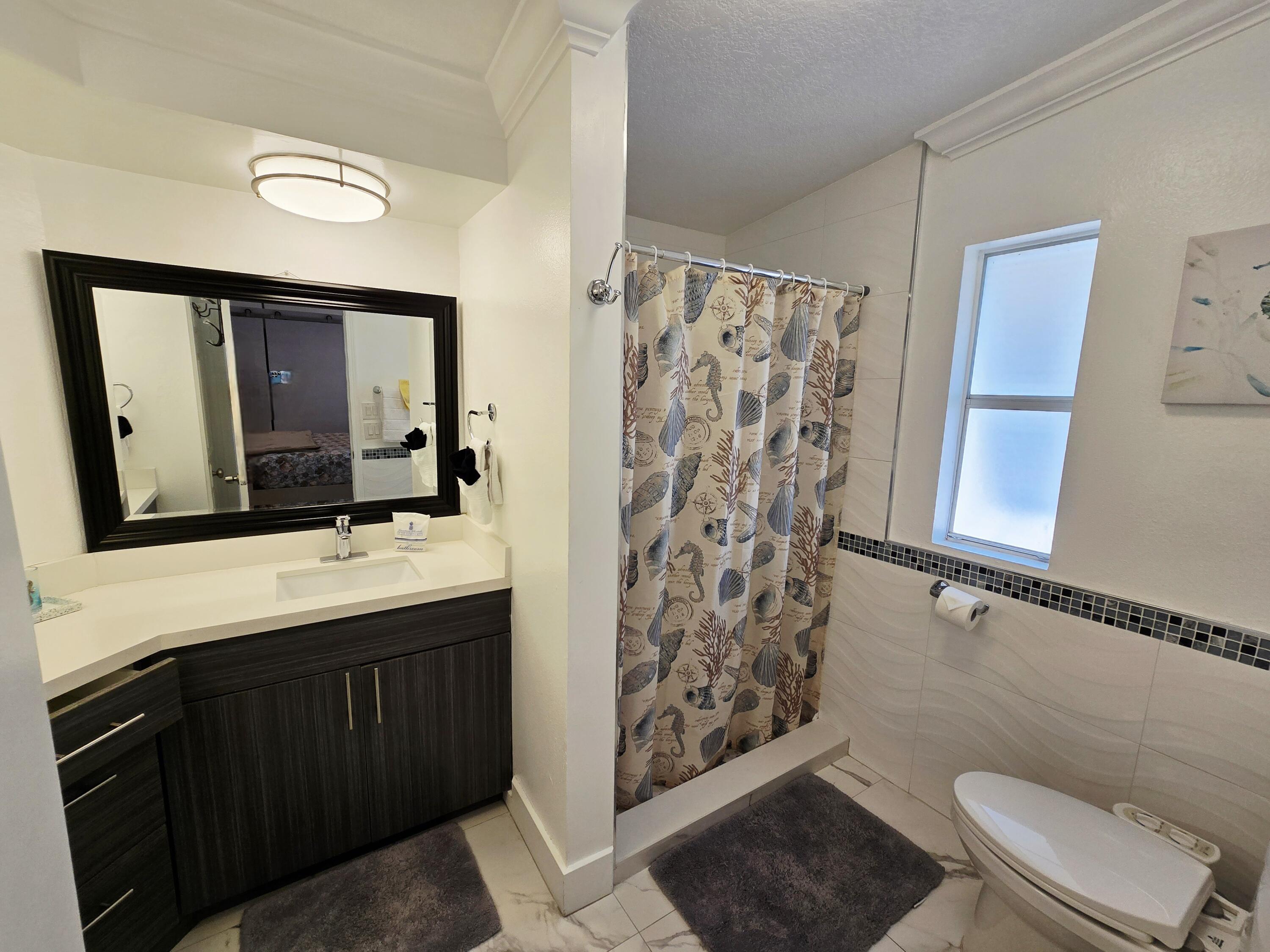 837 91st St Ocean Marathon, FL 33050 - Photo 17 of 27 a bathroom with a sink toilet and shower